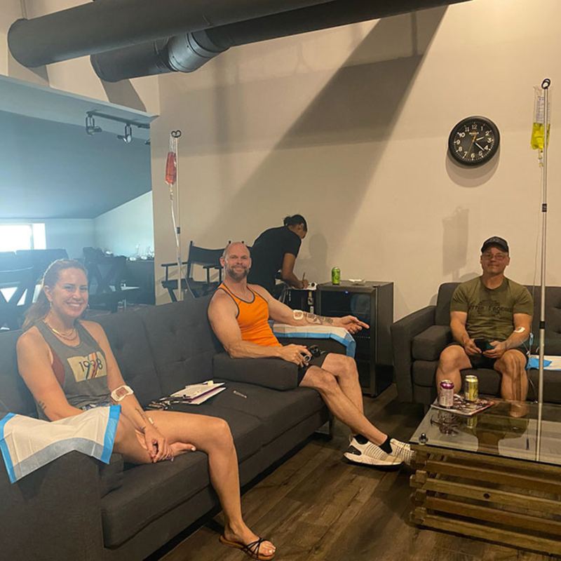 A group on lounge sofas during a mobile IV session at a gym